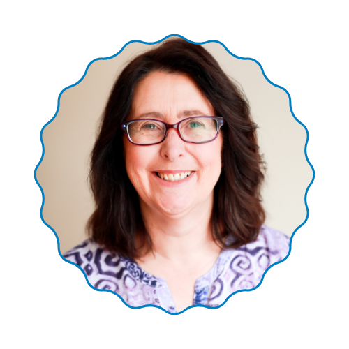 Smiling woman with glasses in a blue patterned top, framed by a scalloped blue border