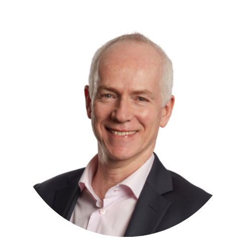 Smiling bald man in a dark blazer and pink shirt on a white background