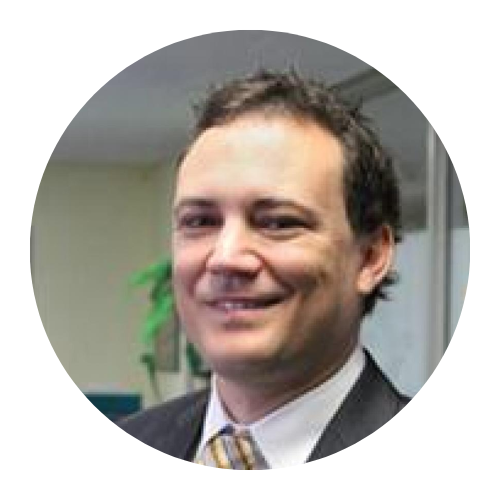 Smiling man in a suit and tie in an office setting