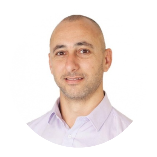 Portrait of a bald man in a light purple shirt on a white background