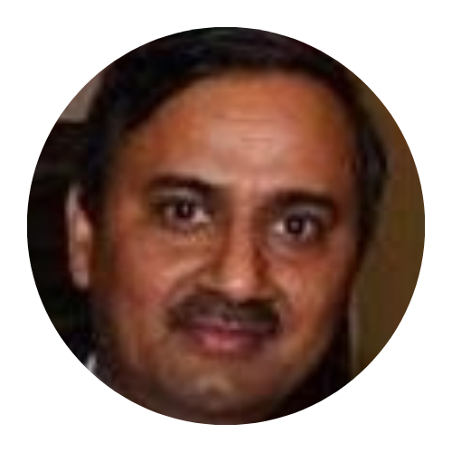 Close-up portrait of a man with short dark hair and a slight smile on a dark background
