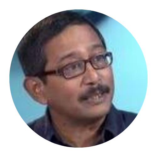 Man with glasses and mustache looking up against a light blue background