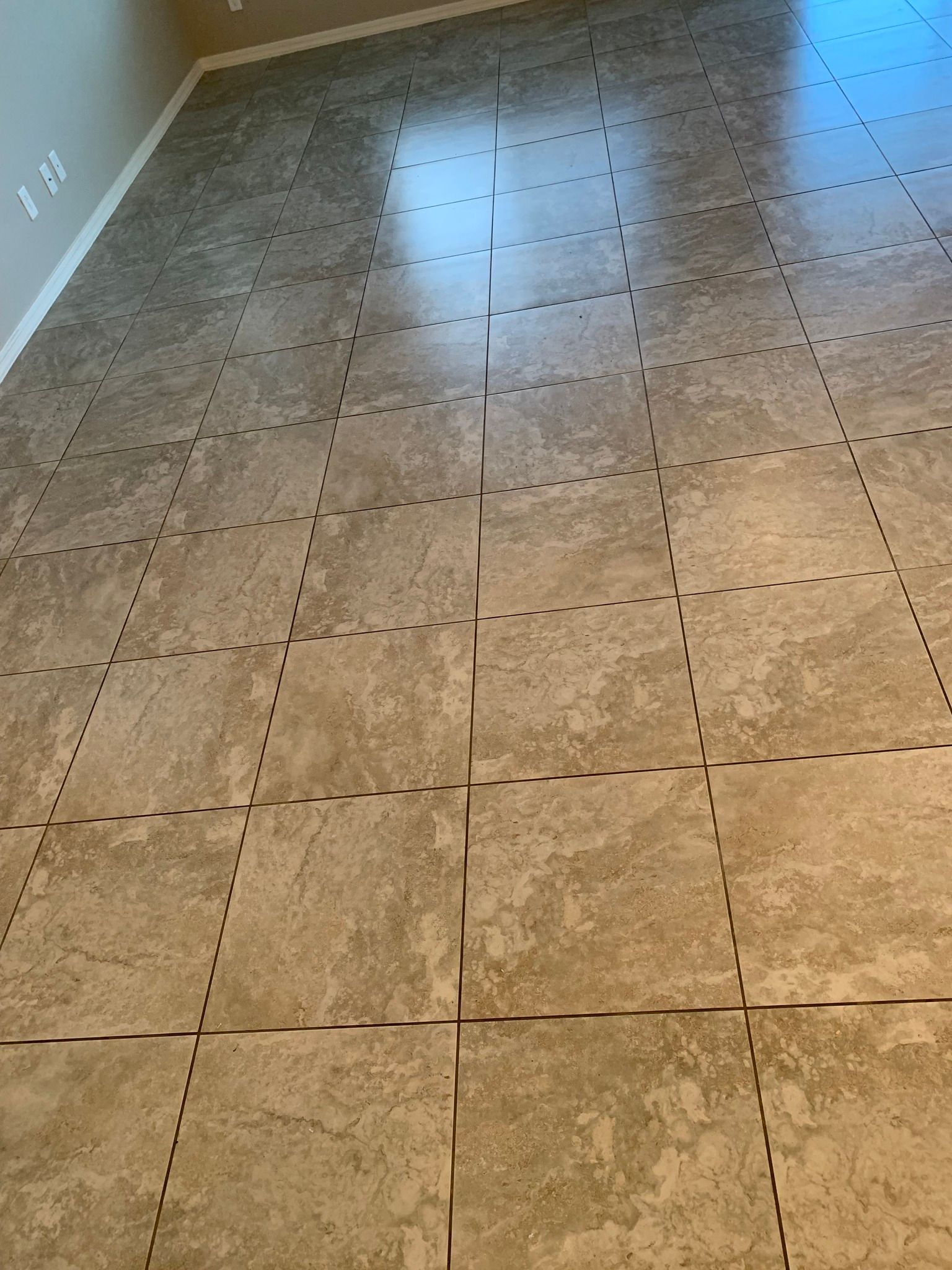A room with a lot of tiles on the floor.
