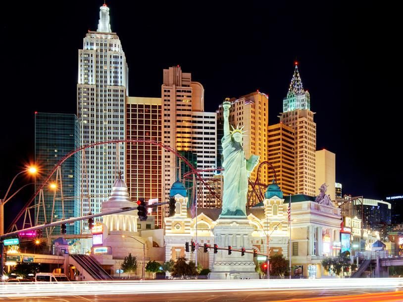 A city skyline with a statue of liberty in the foreground