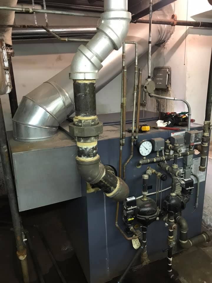 Commercial boiler system with piping and pressure gauges for industrial heating applications
