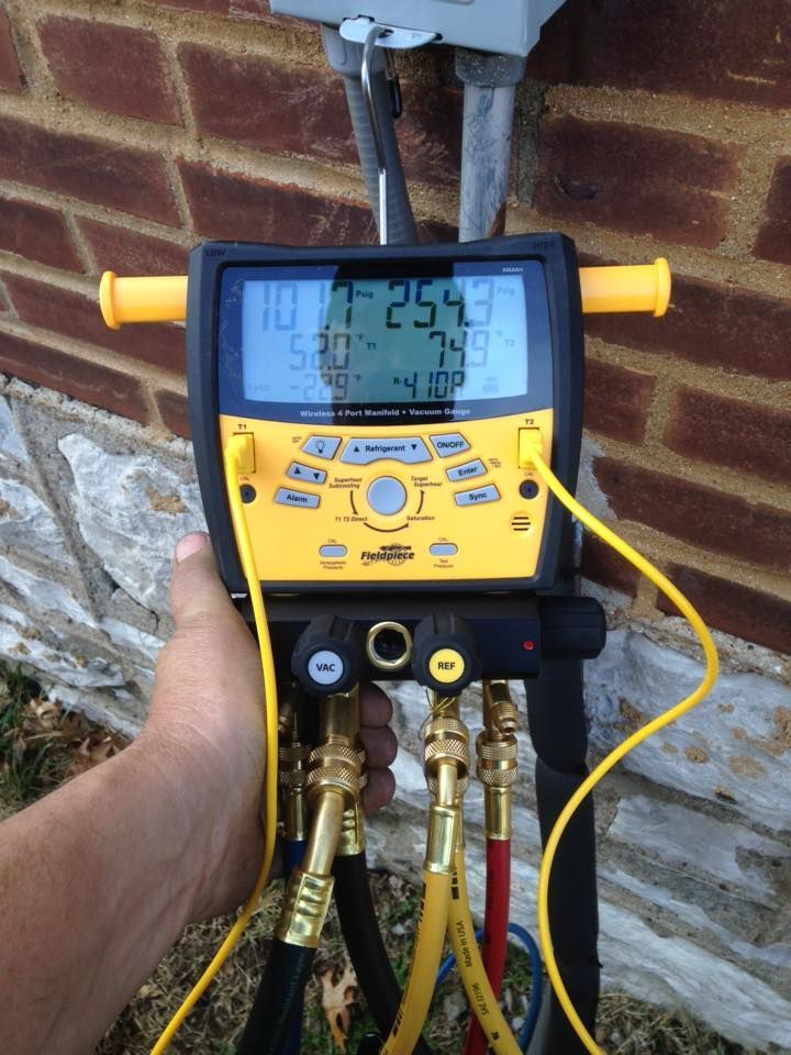 Fieldpiece manifold gauge testing refrigerant pressure during HVAC maintenance service

