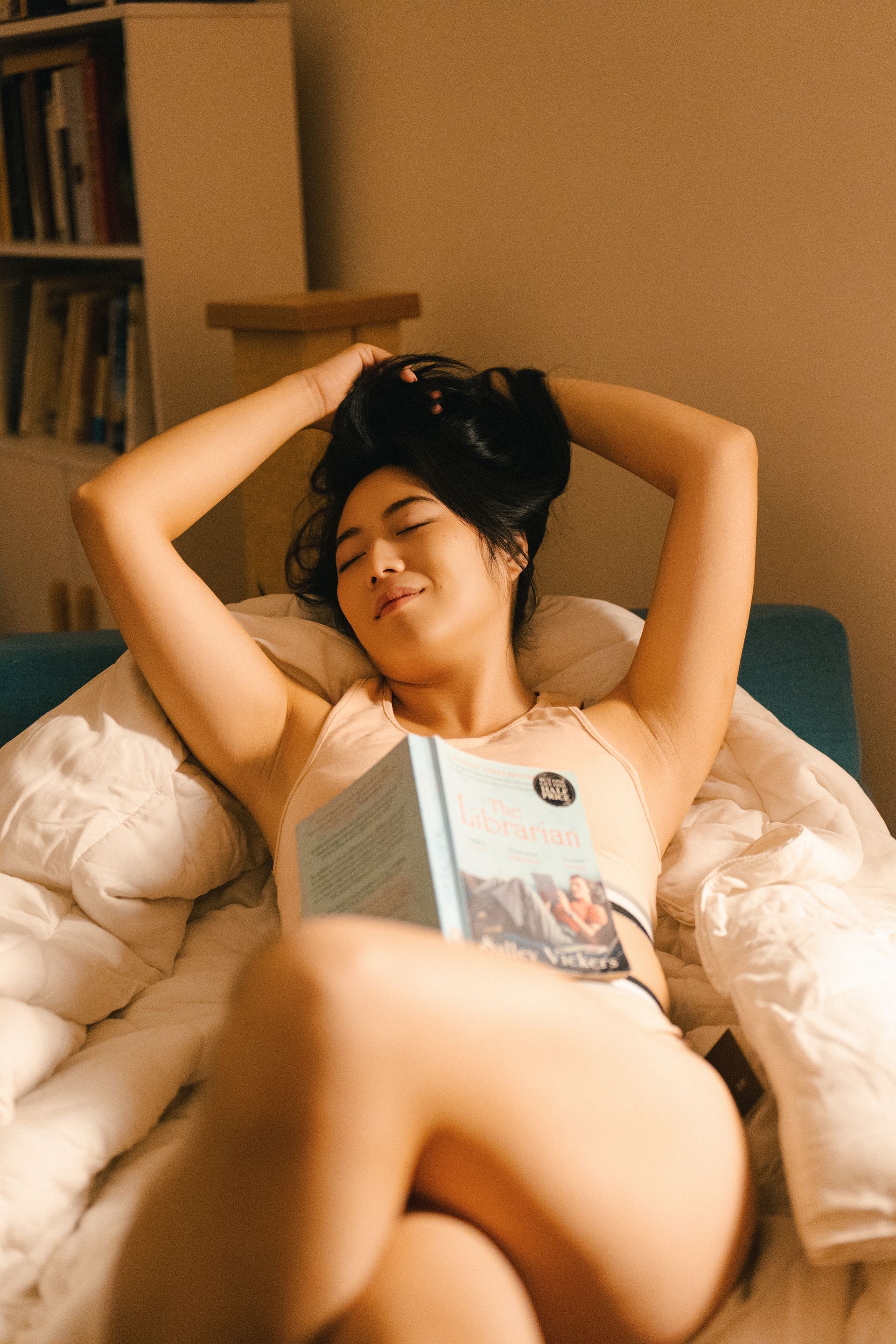 Minnie Lee in a relaxed home setting with a novel — lifestyle model for fashion, wellness, and at-home campaign photography.