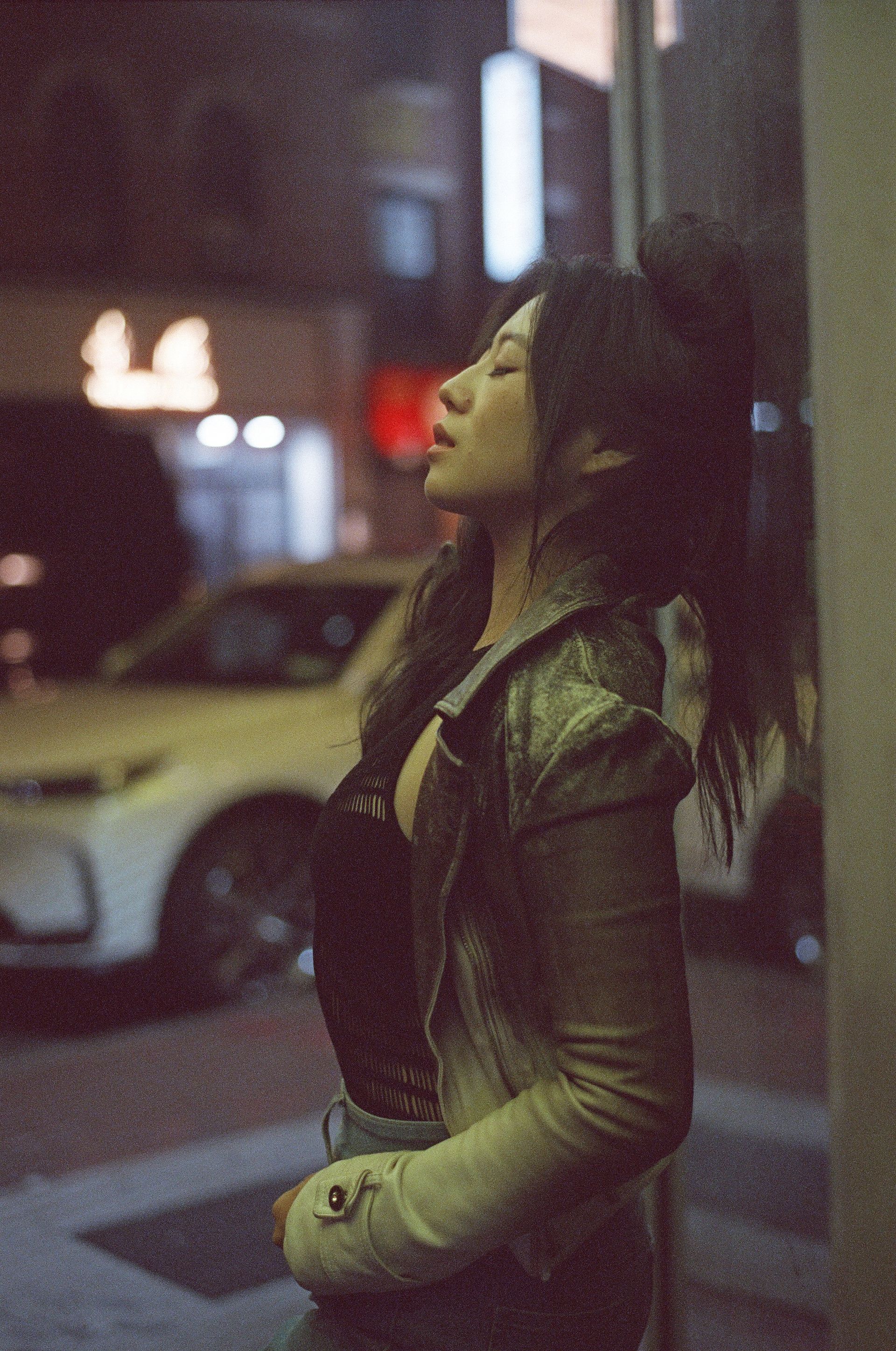 Cinematic night portrait of model Minnie Lee captured by photographer Dan Visintainer, showcasing moody urban lighting and editorial style in Chinatown NYC.