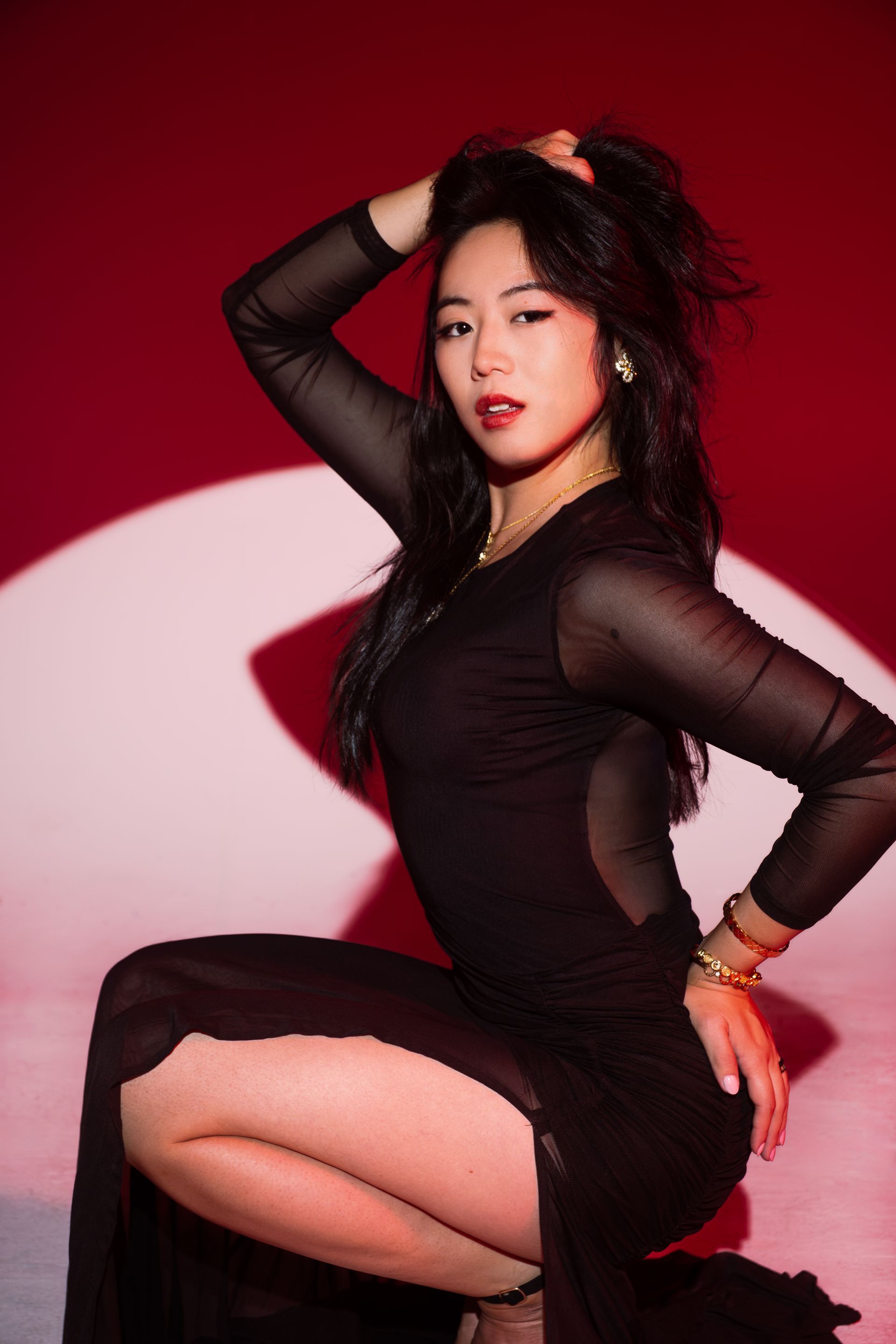 Minnie Lee posing against a red backdrop