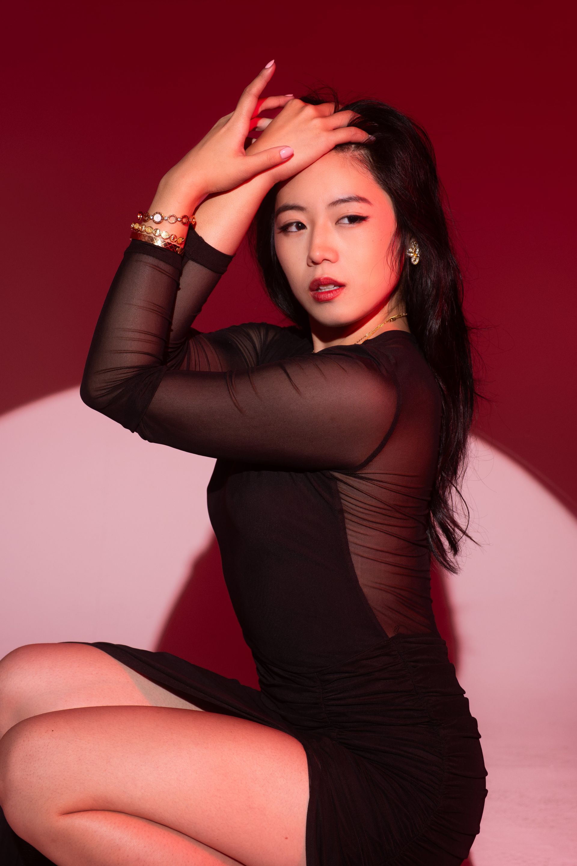 Minnie Lee posing against a red backdrop