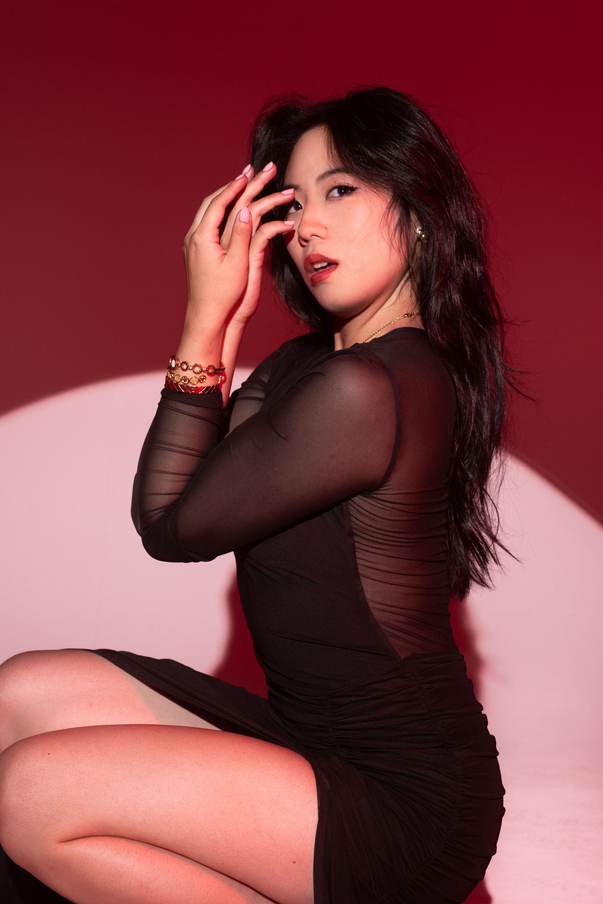 Minnie Lee posing against a red backdrop
