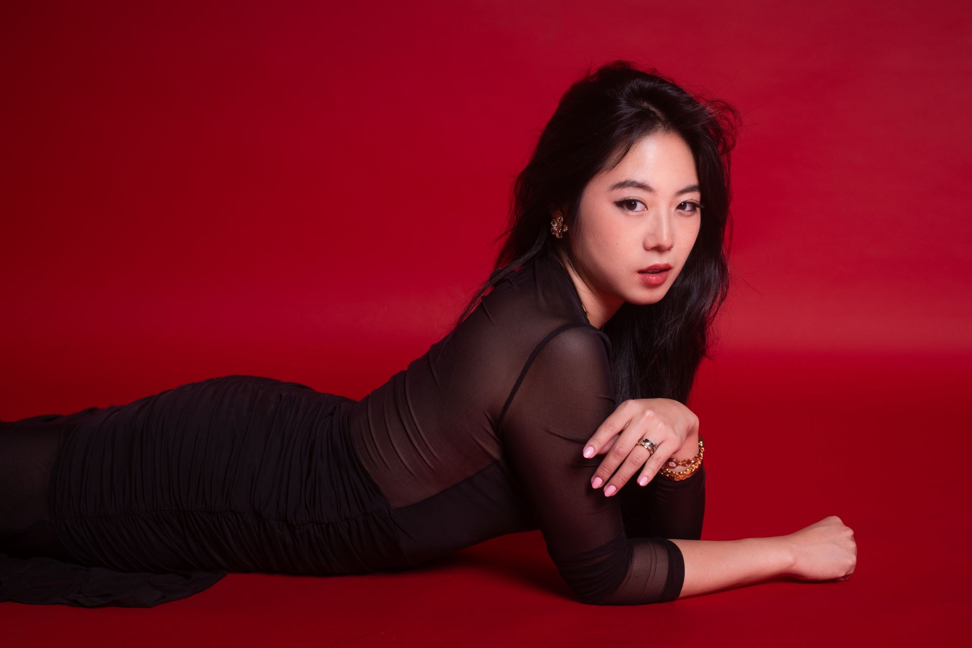 Minnie Lee posing against a red backdrop