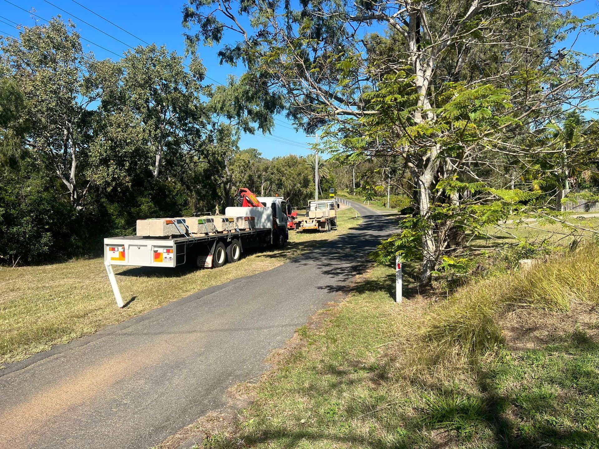 Truck Loaded with Rectangular Blocks Parked on A Narrow Road Lined — J & M Transport Plus in Barmaryee, QLD