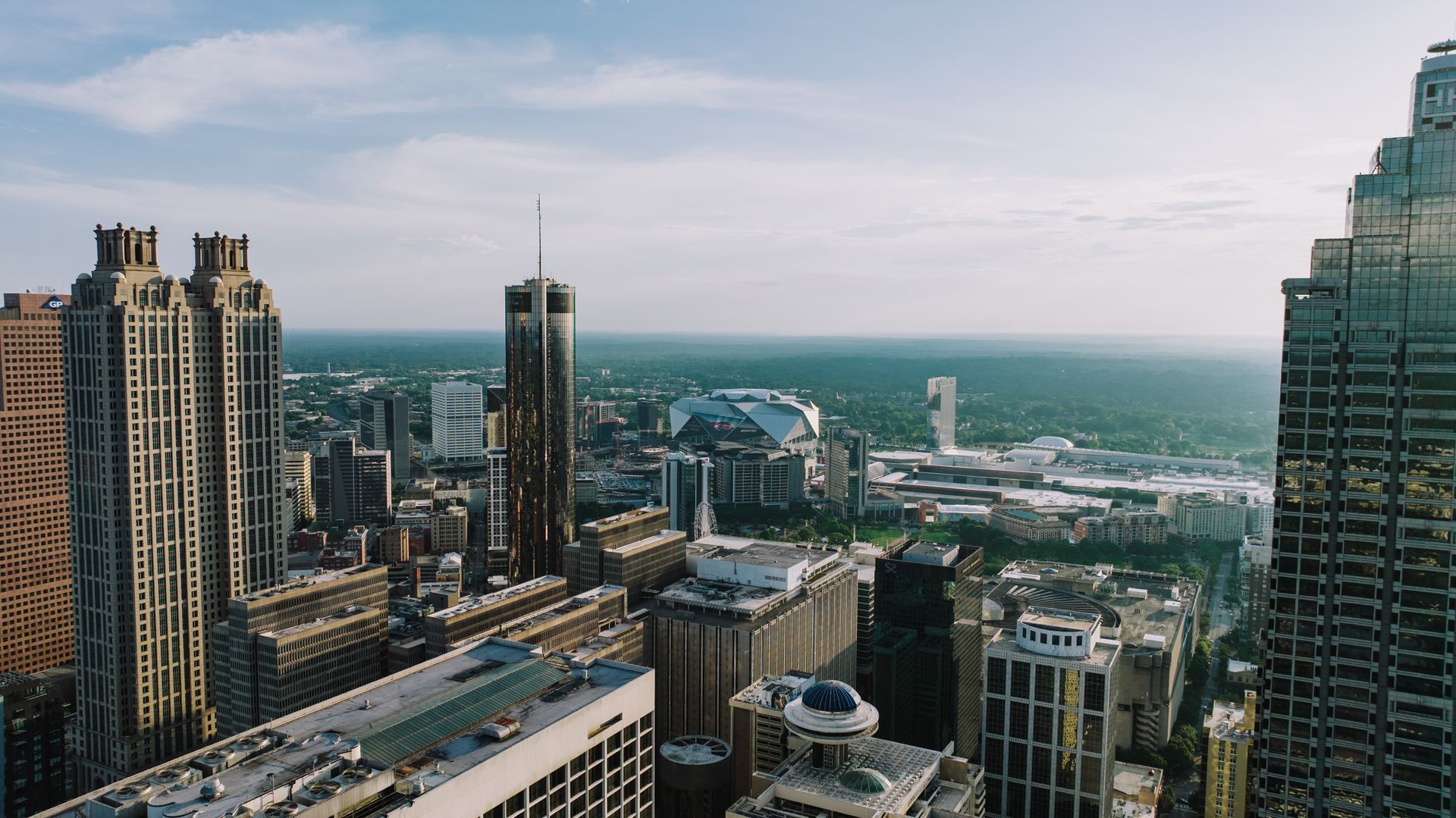 City skyline with tall modern skyscrapers under a hazy sky.