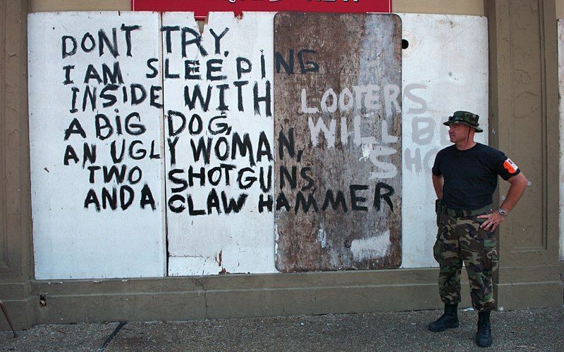 A man standing in front of a sign that says do n't try