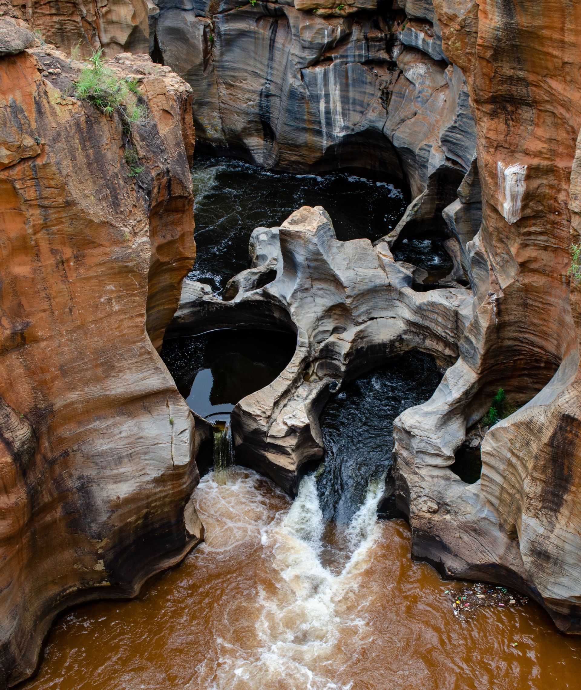 a river flowing through a canyon surrounded by rocks and water .
