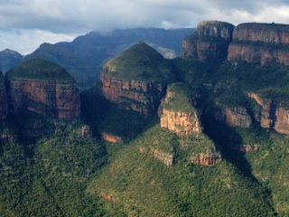 a view of a mountain range with trees and rocks