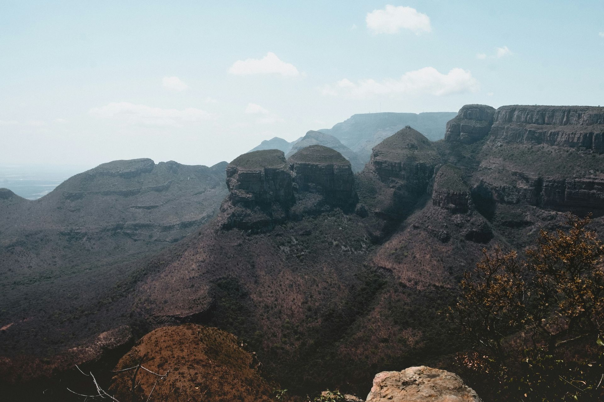 A view of a mountain range with a rock in the foreground