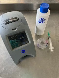Pool water testing kit with a digital reader, chemicals, and a syringe — Cooloola Coast Property Maintenance in Tin Can Bay, QLD