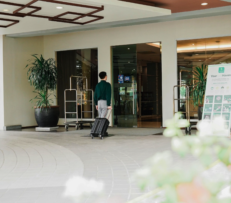 Guest arriving at Harvest Hotel entrance in Cabanatuan City Philippines