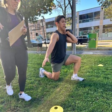 Rodniel crushing the lunges during event 1. A member performing a weighted walking lunge while his judge observes his workout.