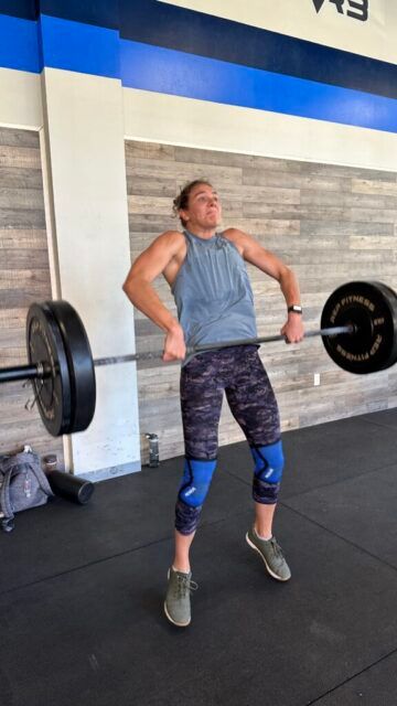 Em's out here showing off during the second event. A female athlete performing a clean in the third pull position.