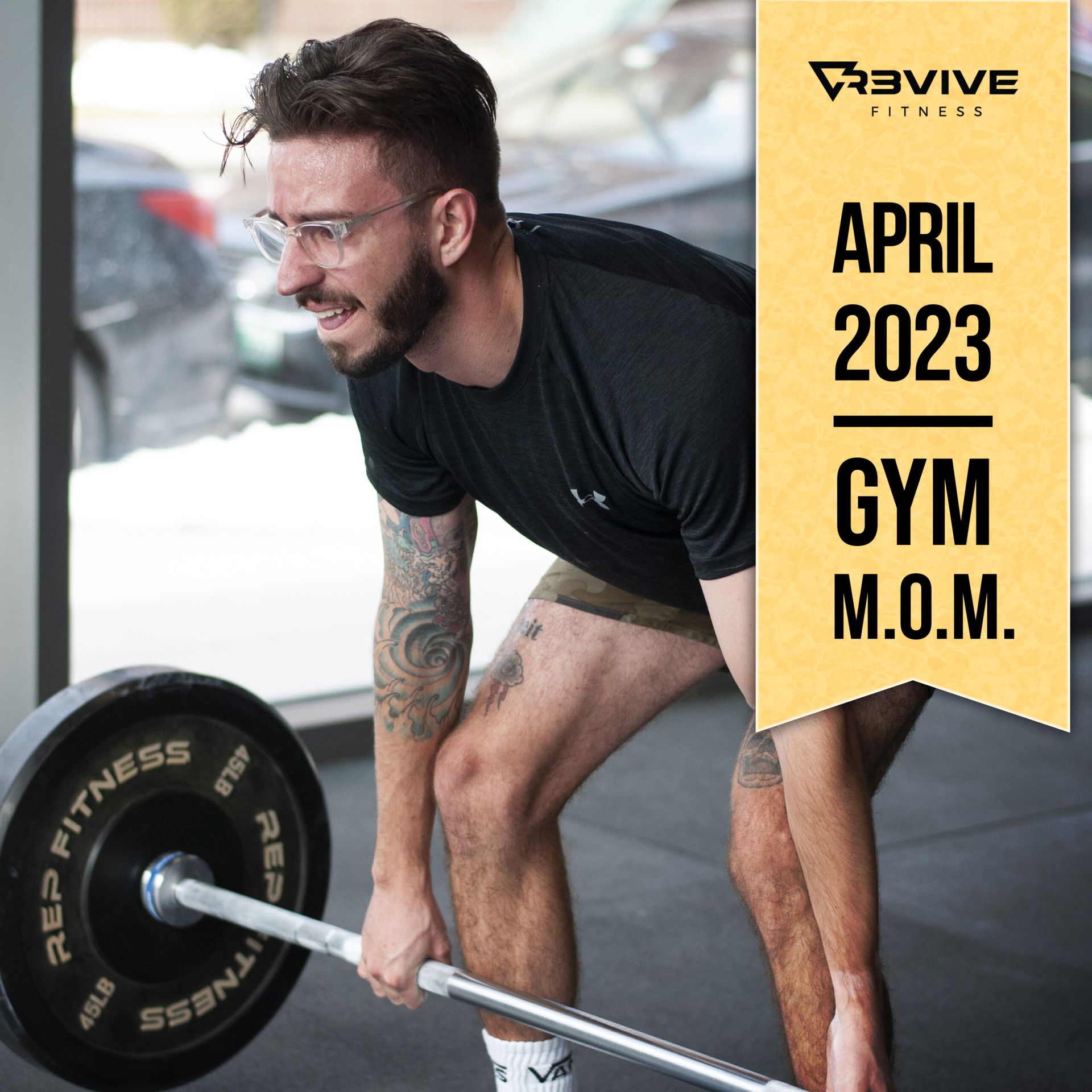 Man deadlifting in gym; tattoo on arm; 