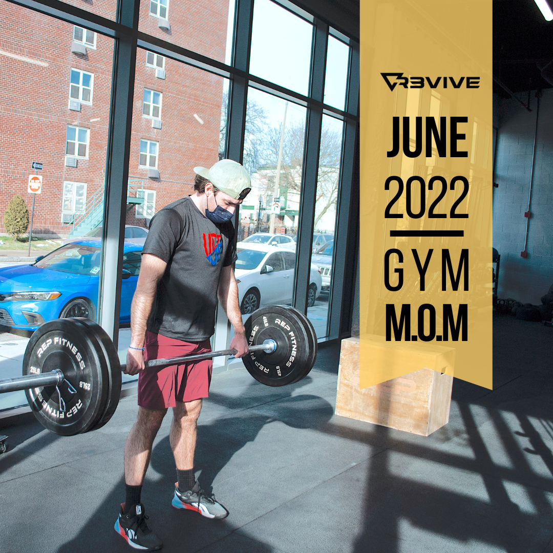 Man lifting a barbell in a gym with a 