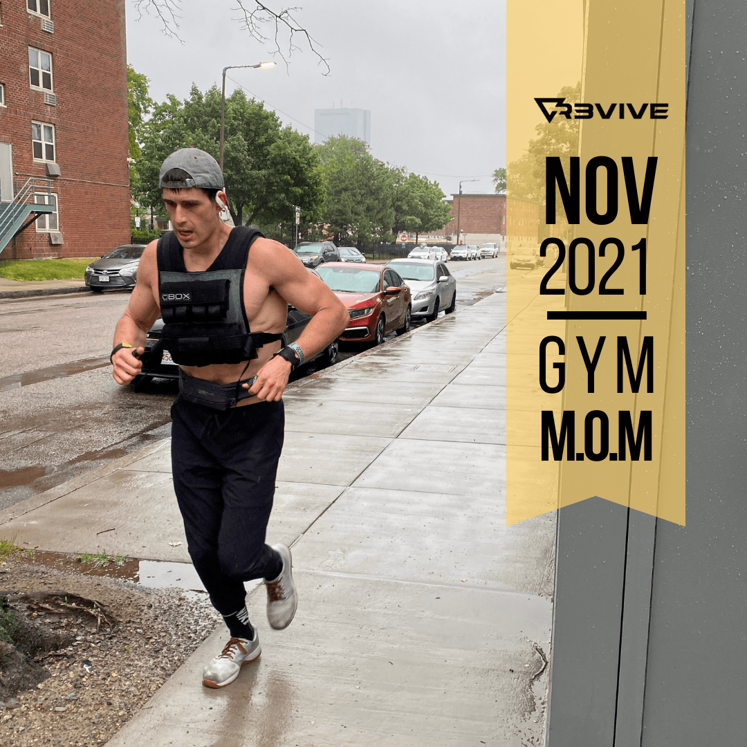 Man runs outside in rain, wearing a vest. 