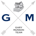 Logo: Gray arrows crossing with a house held in a hand; letters G and M;