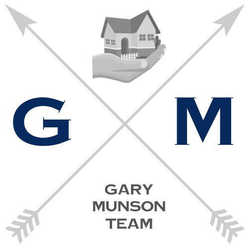 Logo: Gray arrows crossing with a house held in a hand; letters G and M;