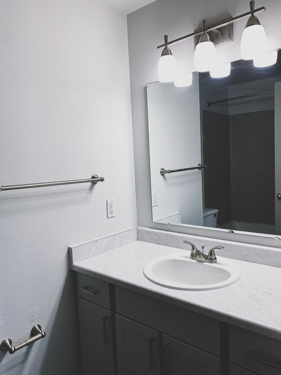 A bathroom with a sink and a mirror