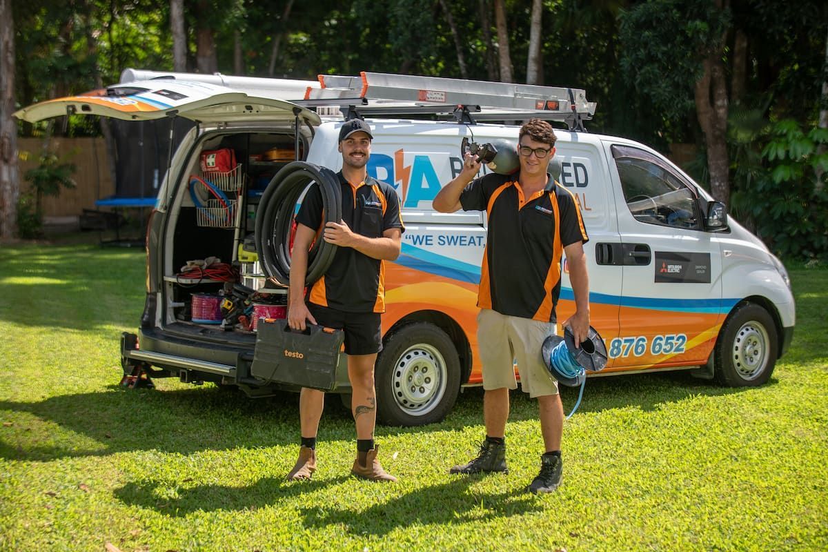 Two Men Are Standing in Front of A Van — Recharged Air & Electrical in Stratford, QLD