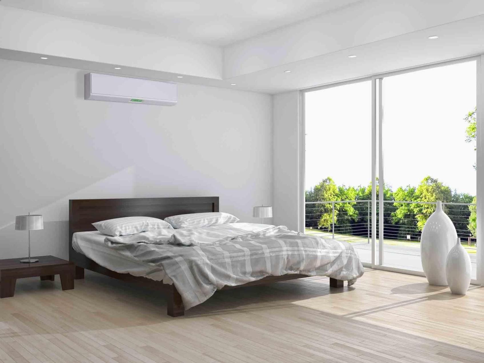 A Bedroom With a Large Bed, Sliding Glass Doors, and Air Conditioner — The Cool Guys In Holtze, NT