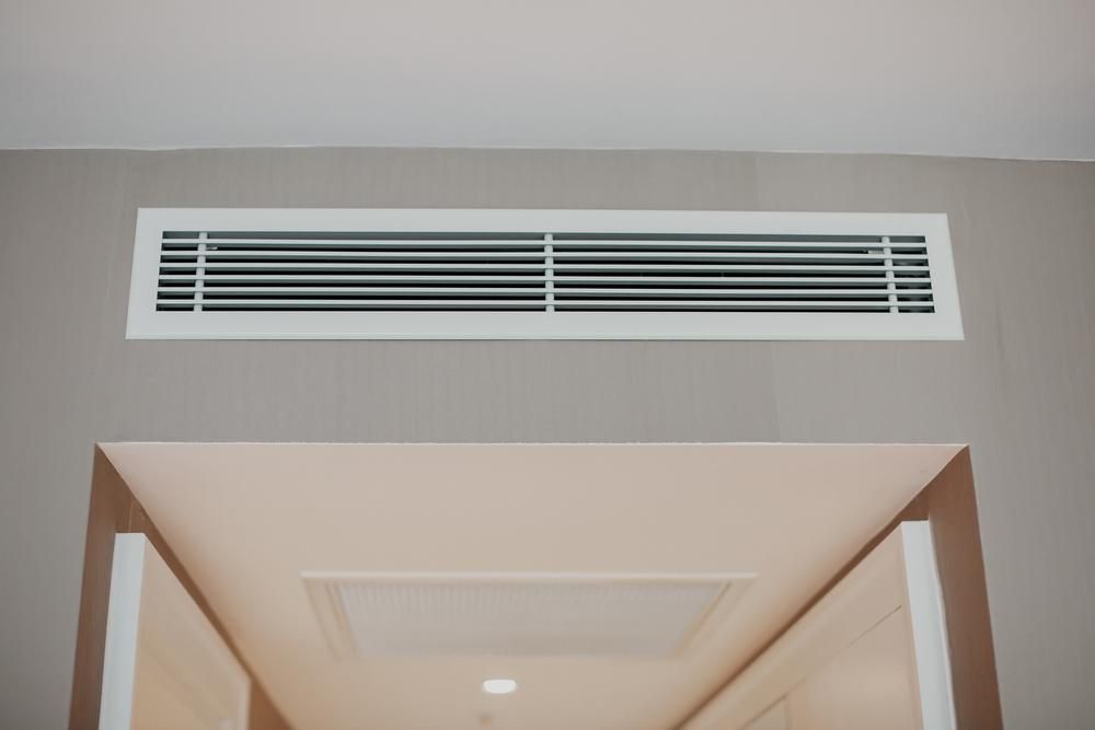 A White Air Vent is Hanging From the Ceiling of a Room — The Cool Guys In Holtze, NT