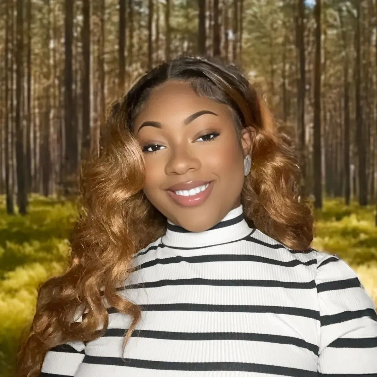 Smiling woman in a black-and-white striped top standing in a sunlit forest