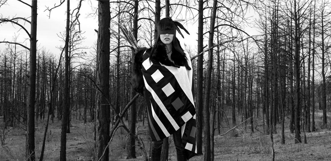 Warrior standing in the woods with bow and arrows
