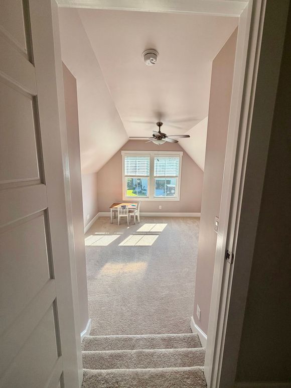 A living room with a wooden floor and a window.