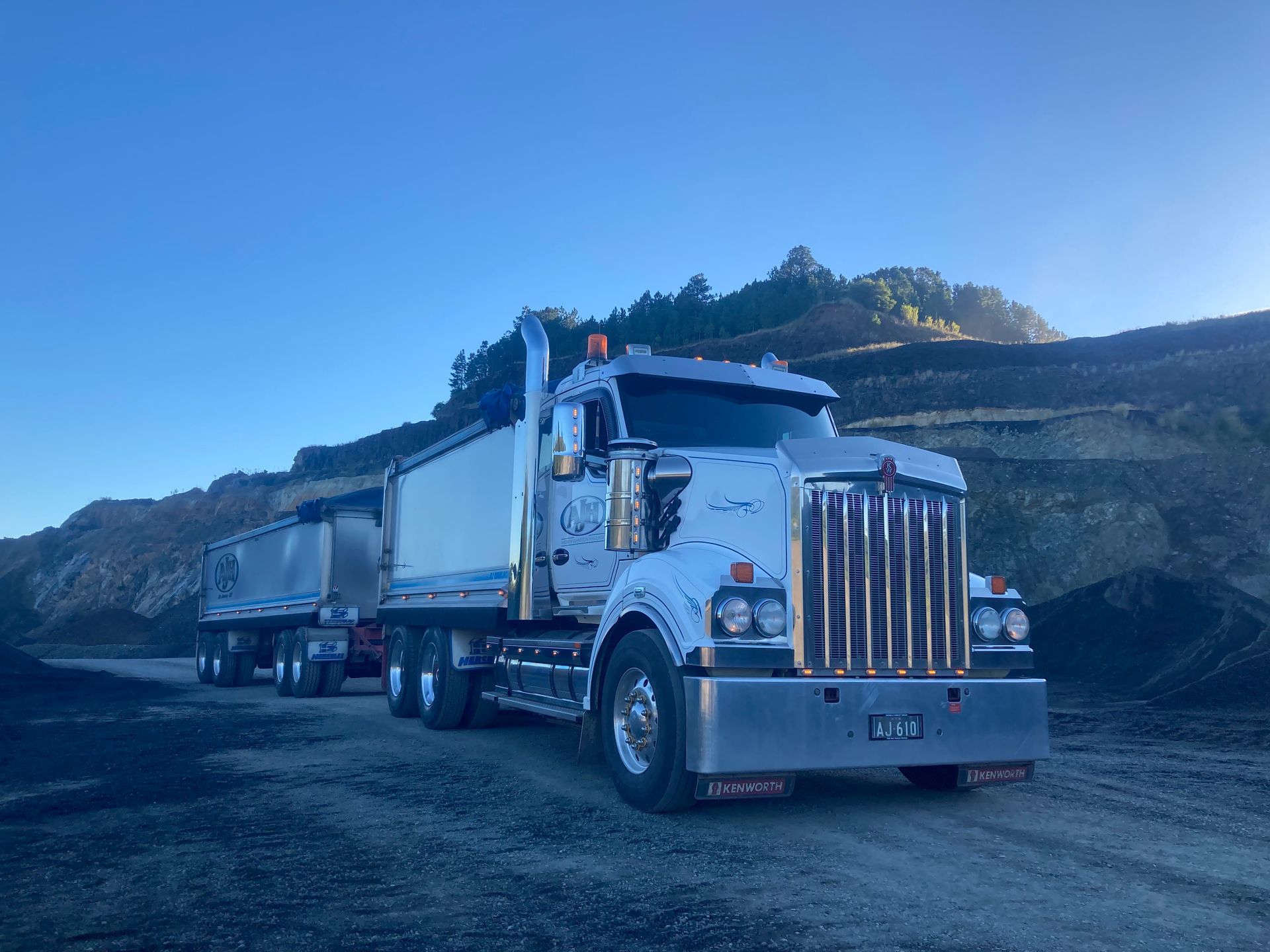 A Large Dump Truck is Parked on the Side of a Dirt Road — Andrew Johnston Haulage In Ewingsdale, NSW