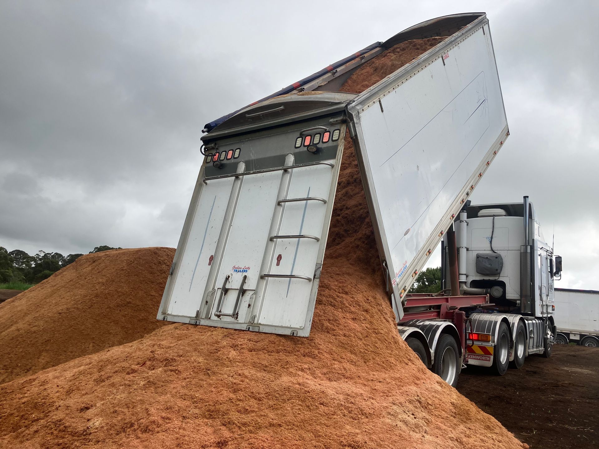 A Semi Truck is Dumping a Large Pile of Dirt  — Andrew Johnston Haulage In Ballina, NSW