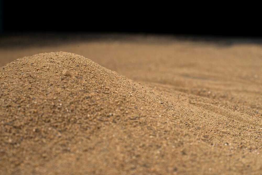 A Pile Of Brown Sand With A Black Background — Andrew Johnston Haulage In Grafton, NSW