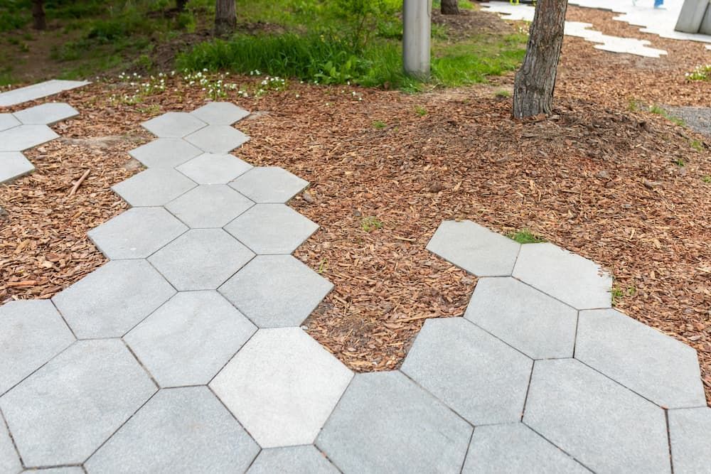 A Walkway Made Of Hexagonal Tiles With A Tree In The Background — Andrew Johnston Haulage In Gold Coast, QLD