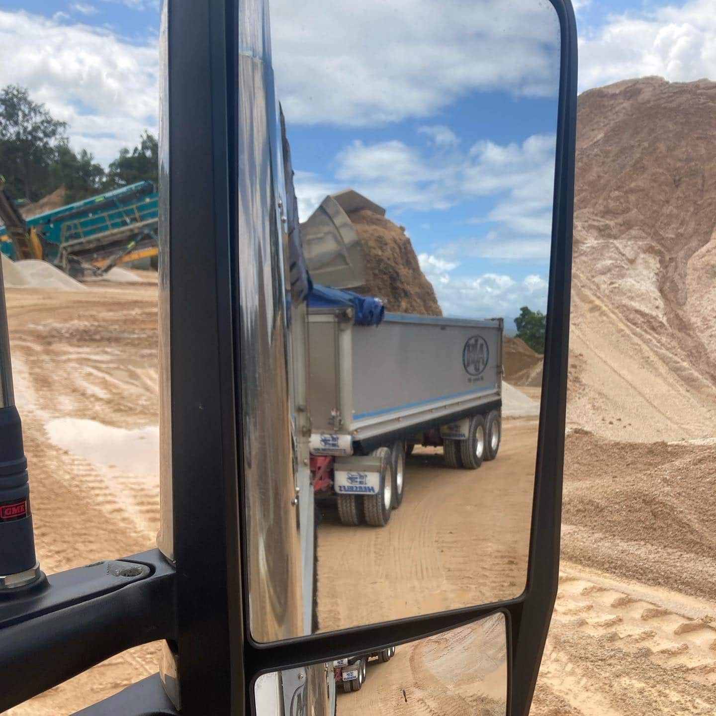 A Dump Truck Is Reflected In A Side View Mirror — Andrew Johnston Haulage In Ewingsdale, NSW