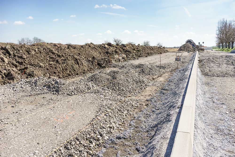 A Large Pile Of Dirt And Gravel Is Sitting On The Side Of A Road Under Construction — Andrew Johnston Haulage In Casino, NSW