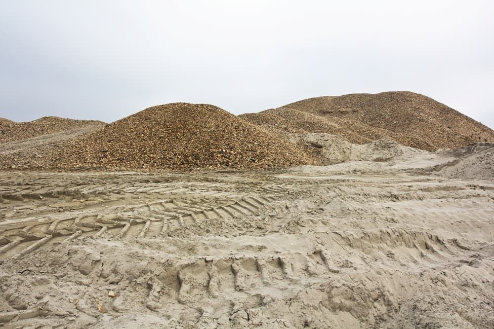 A Pile Of Dirt And Rocks With Tire Tracks In The Dirt — Andrew Johnston Haulage In Kyogle, NSW