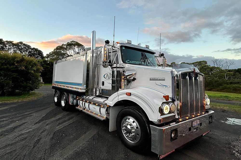 A White Kenworth Truck Is Parked On The Side Of The Road — Andrew Johnston Haulage In Tweed Heads, NSW
