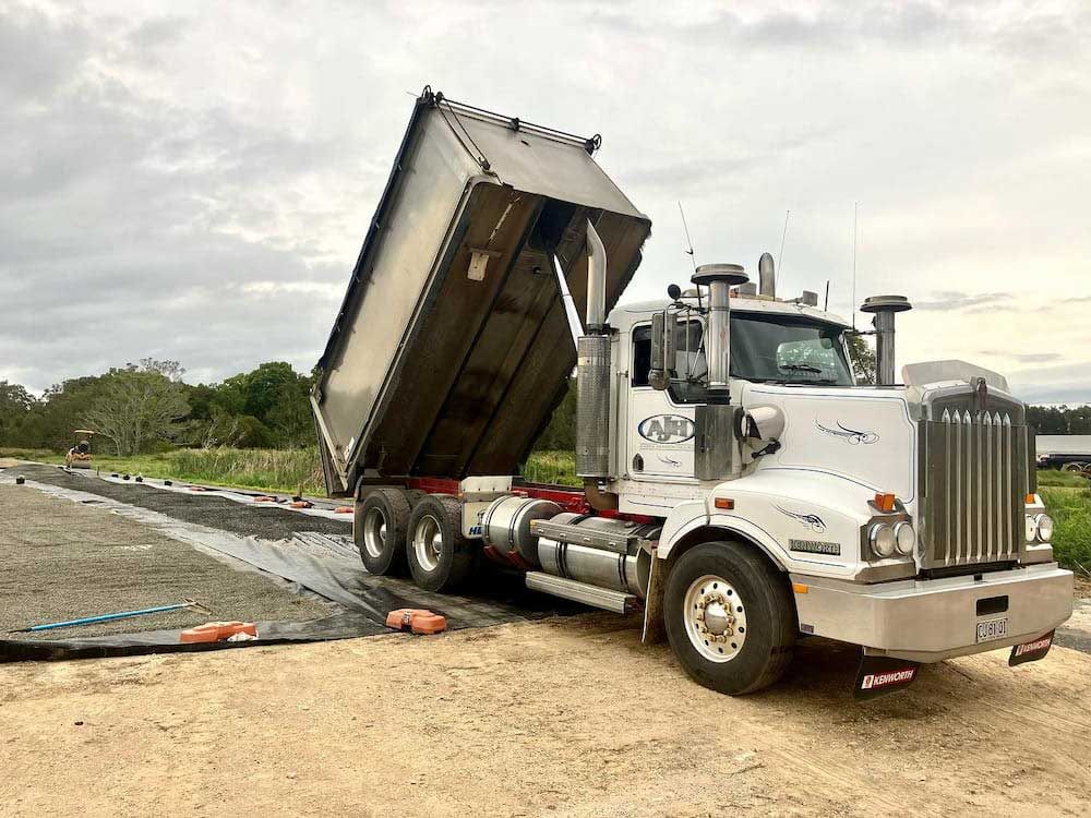 A White Volvo Truck Is Parked On The Side Of The Road — Andrew Johnston Haulage In Murwillumbah, NSW