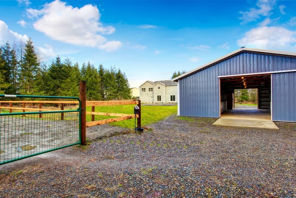 A Barn With The Door Open And A Fence In Front Of It — Andrew Johnston Haulage In Byron Bay, NSW