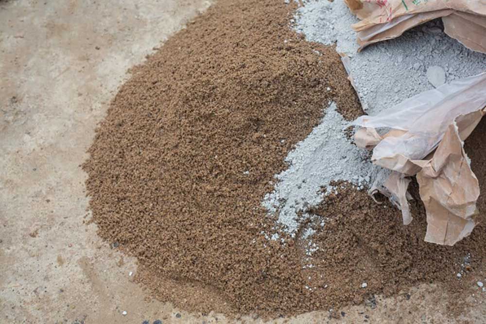 A Pile Of Sand And Cement On The Ground Next To A Bag Of Cement — Andrew Johnston Haulage In Lismore, NSW