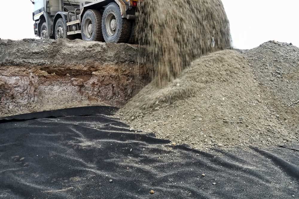 A Large Truck Is Dumping Dirt Into A Pile — Andrew Johnston Haulage In Casino, NSW